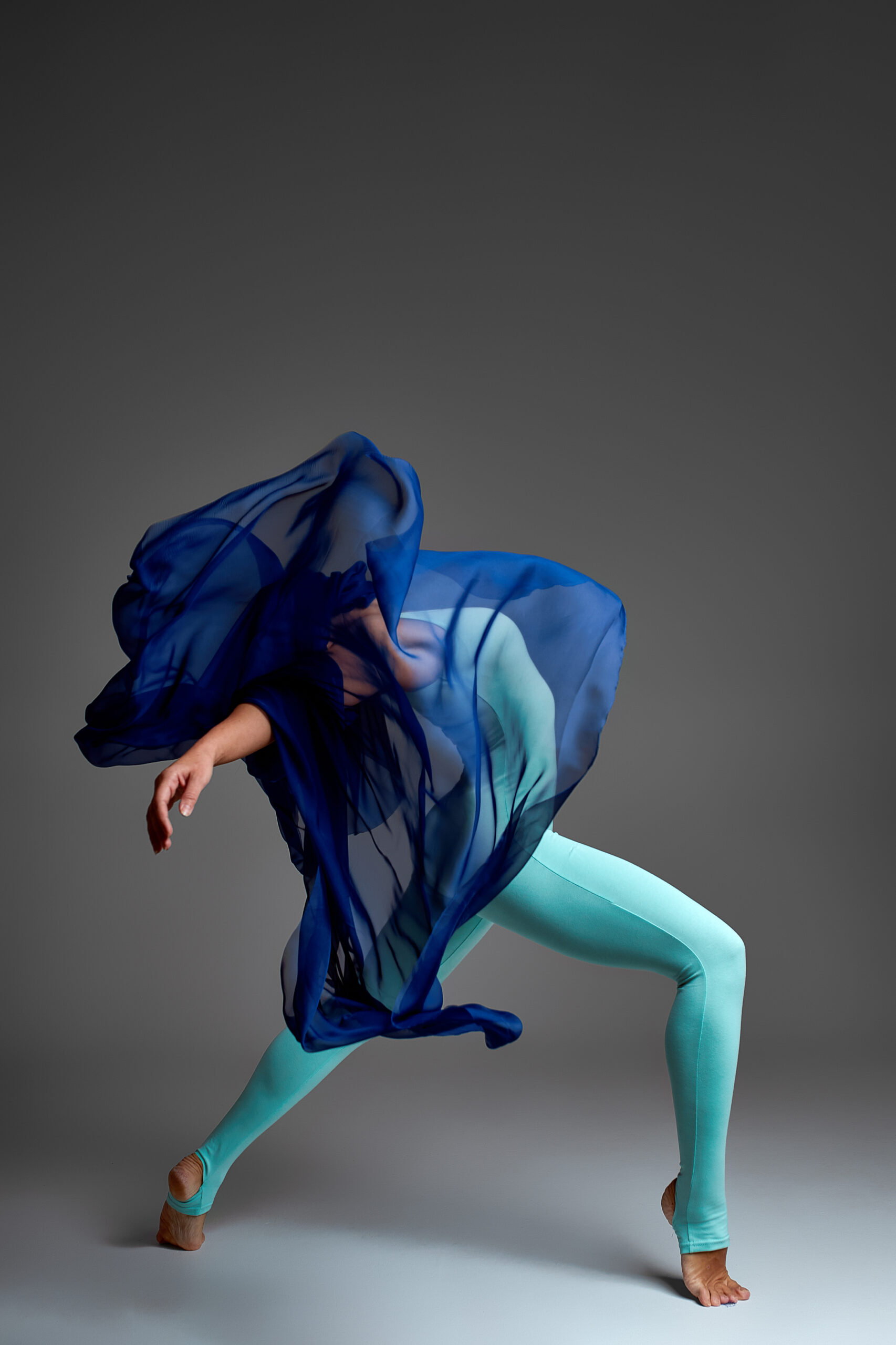 Ballerina Dancing with Silk Fabric, Modern Ballet Dancer in Fluttering Waving Cloth, Gray Background.